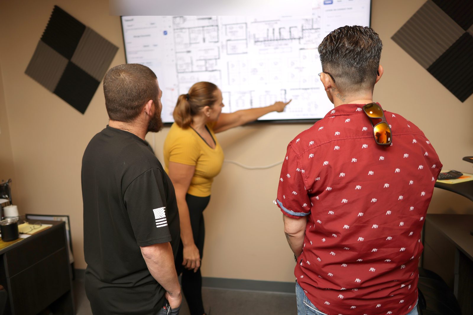 PHP Painting team reviewing a project takeoff on a large display